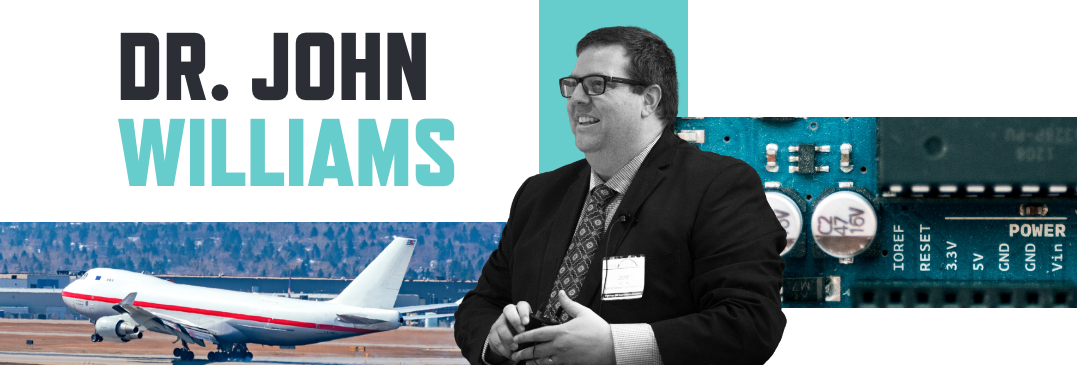 Image of a man wearing glasses, suit and tie with background images of an airplane fall and circuit board and the name Dr. John Williams in bold font.