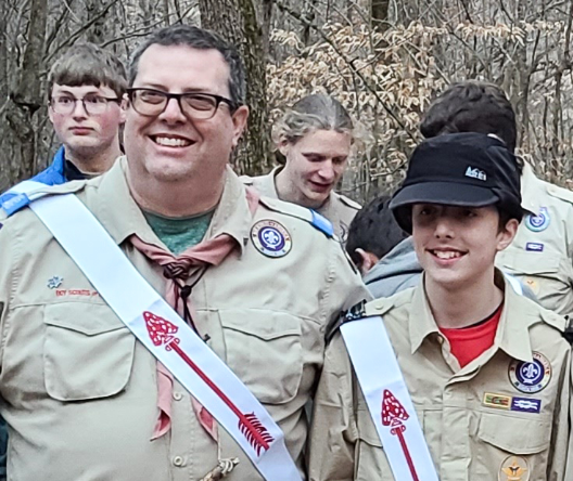 Dr. John Williams wearing boy scouts uniform standing with other scouts.