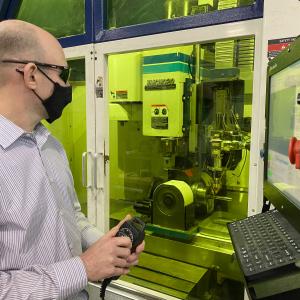 REMADE staff member works on equipment for remanufacturing