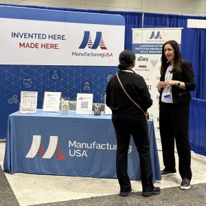 Zara Brunner from NIST interacts with an attendee at the Manufacturing USA booth at TechConnect. 
