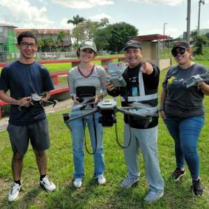 Photo of students and a faculty member from University of Puerto Rico at Mayagüez, College of Mechanical Engineering holding drones.