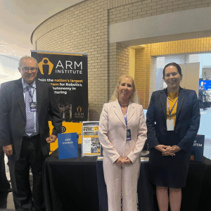 Photo of ARM Institute staff in front of their table at the PA AI Energy Summit