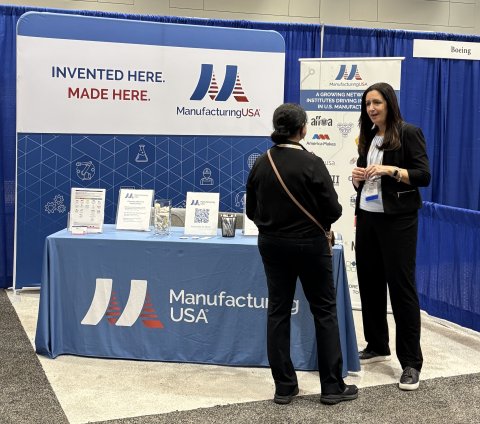 Zara Brunner from NIST interacts with an attendee at the Manufacturing USA booth at TechConnect. 