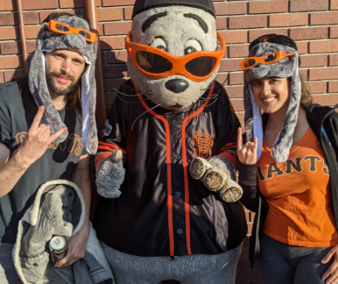 Photo of Cassandra Turgman and her husband with the mascot of the San Francisco Giants