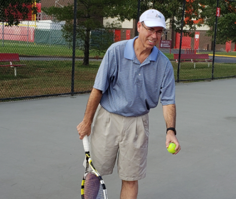 Photo of Paul Perkins playing tennis