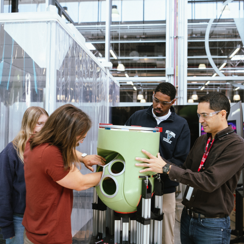 Photo of people looking at a technology at MxD