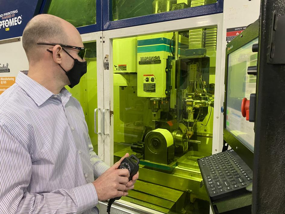 REMADE staff member works on equipment for remanufacturing