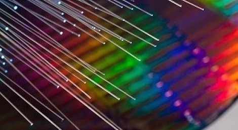 A silicon photonics wafer and optical fibers.