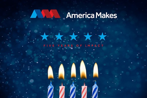 Photograph of people standing in front of an image of 5 candles and the text “Five years of impact.  America Makes.